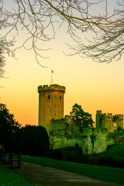 Ancient European medieval architectural building castle in golden autumn light with the blue sky background during autumn