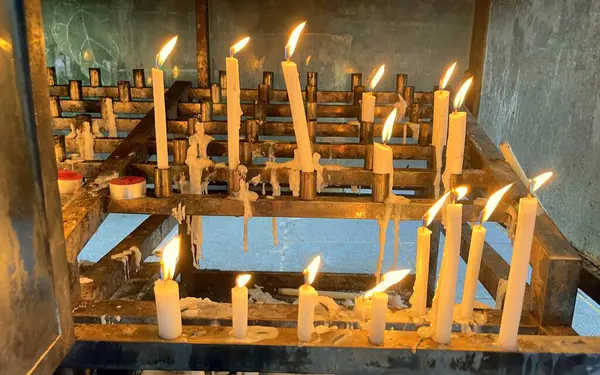 Many Prayers Candle Flames Glowing Dark Create Spiritual Atmosphere —  Fotos de Stock