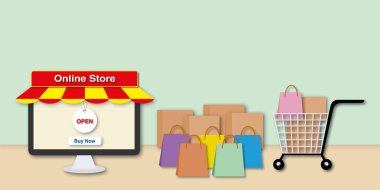 Renkli kağıt torbaları ve pastel yeşil arka planda kutusu olan masaüstü bilgisayarı. Çevrimiçi alışveriş ya da online mağaza konsepti. Metin için yer aç. Kağıt tasarım biçimi.