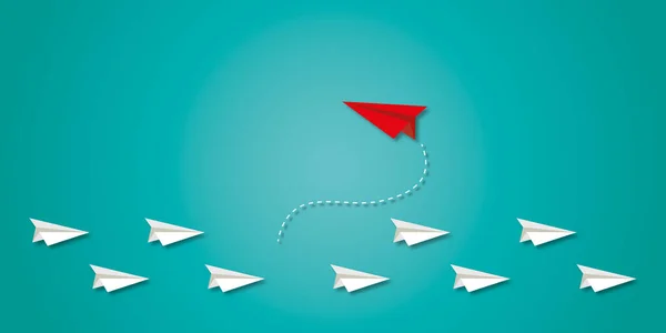 Red paper plane change direction from group on green background as metaphor for business creativity new idea to discovering new business options, Individual and unique leader. copy space. paper art.