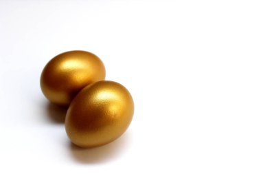 Altın yumurtalar beyaz arka planda izole edilmiş.