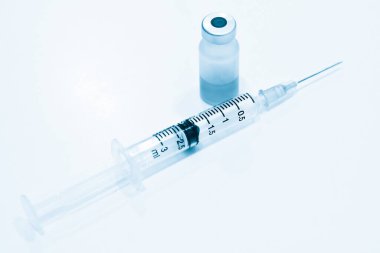 İlaç şişesi, 3 ml plastik şırınga ve beyaz arka planda iğne izole edilmiş.