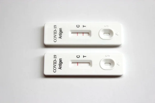 Positive and negative test result of Covid-19 antigen test kit on the white background
