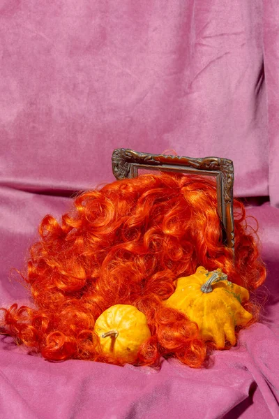 Perücken Haar Fotorahmen Neben Kürbissen Auf Rosa Stoff Hintergrund — Stockfoto