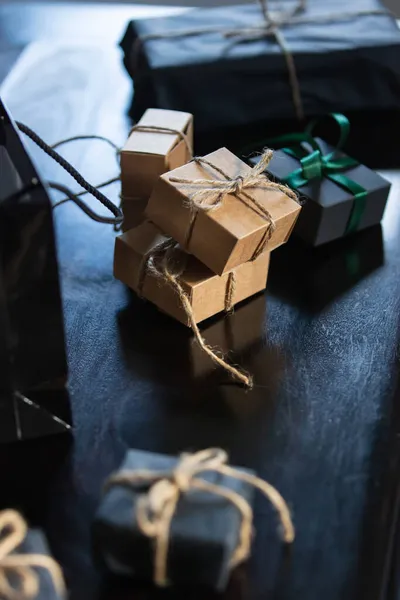 Paper Wrapped Gifts Black Table Side View — Stock Photo, Image