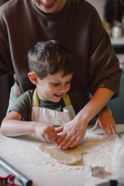 mother and son preparing flour for cookies in the kitchen
