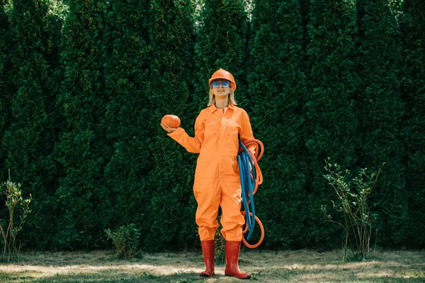 Stylish Woman Orange Suit Hardhat Pipes Sunglasses Pumpkin Green Grass — Fotografia de Stock