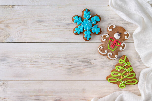 gingerbread cookies lie on white wooden background, copy space, selective focus