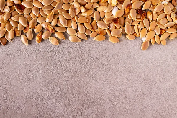Dried Pumpkin Seeds Scattered Beige Background Copy Space — Stock Photo, Image