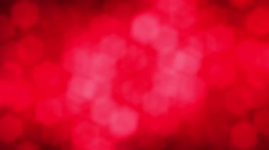 Abstract red blurred hexagon festive motion 3D animation. Holiday concept backdrop. De-focused light red particles ember over black background.
