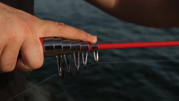 Vara de pesca, o homem está puxando uma vara de pesca com as mãos, close-up, 2 versões — Vídeo de Stock