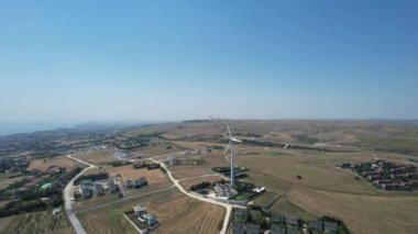aerial shot wind turbine and rural settlement