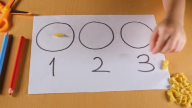 preschool math activity, close-up kid doing preschool math activity with hands