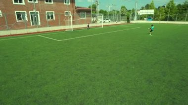 boy scoring goal, aerial boy scoring goal on soccer field