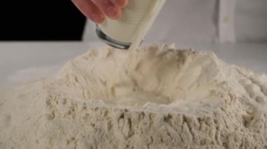 adding milk to flour, adding milk to flour to make dough 