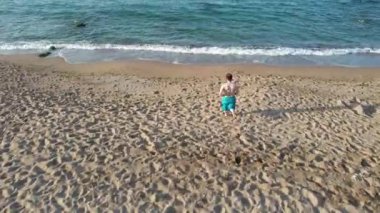 running beach, man running beach and jumping to sea