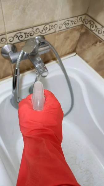 Hand Rubber Glove Applies Plaque Remover Bathroom Faucet Background Beige — Stock Photo, Image