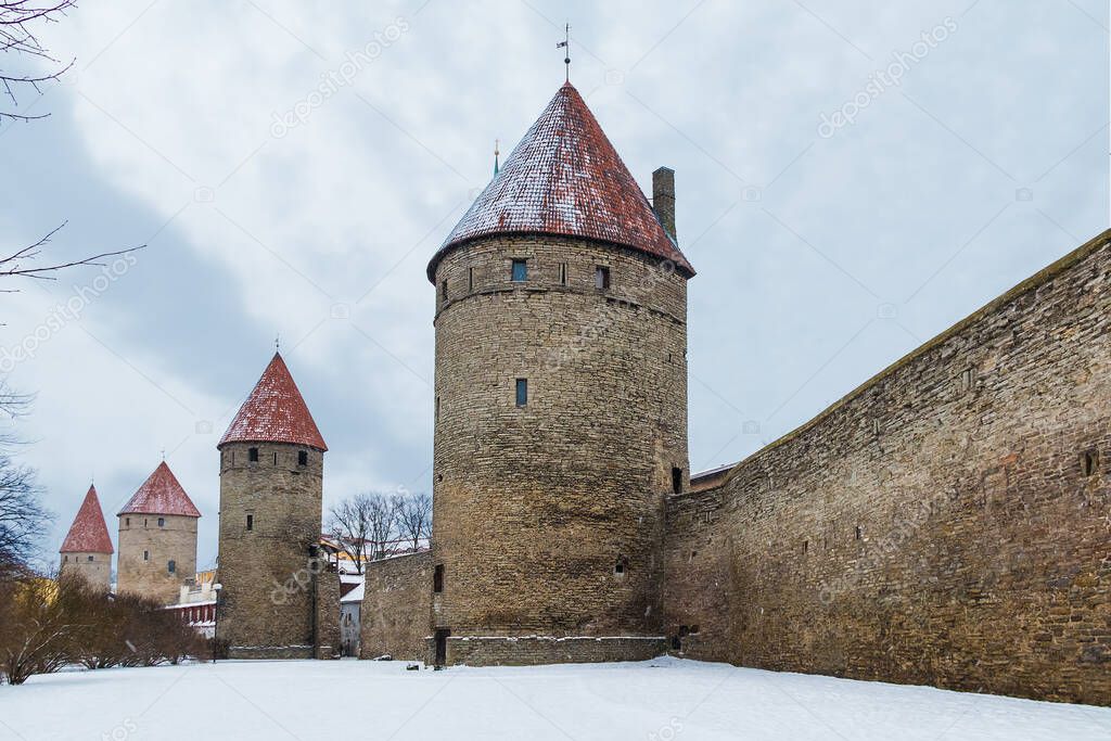 Perspective view of walls and towers of the Tallinn Old Town in snowy winter day, Estonia