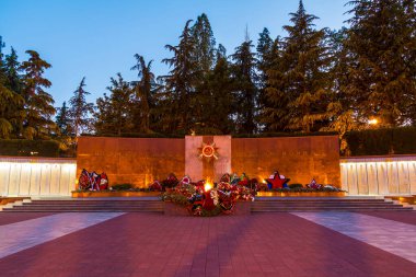 Sochi, Russia - May 11, 2017: Eternal flame of Zavokzalnyy Memorial Complex at twilight. Translate of the text is 