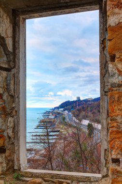 View of the seaside from the window of the abandoned old mansion called Dacha Kvitko in overcast day, Sochi, Russia