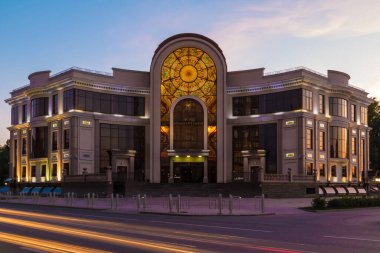 Beautiful front view of the illuminated Wedding Palace on the Malygina Street in summer day at twilight, Tyumen, Russia