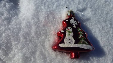 Toy red spruce on a background of snow