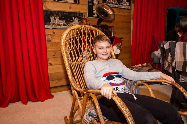 Boy Sits Rocking Chair Winter Log Cabin — Stock Photo, Image