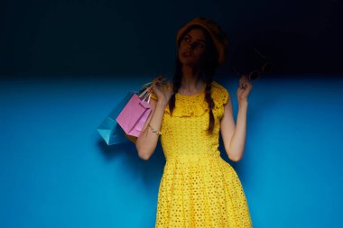 Sarı şapkalı güzel bir kadın. Alışveriş tarzı moda stüdyo modeli.