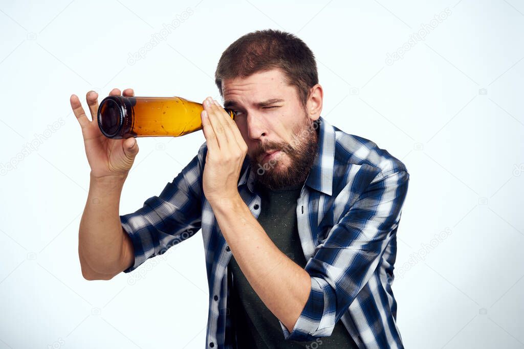 a man in a plaid shirt beer alcohol emotions fun light background