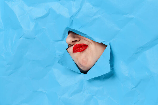 womans face breaks through blue mockup close-up