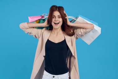 Çekici bir kadın alışveriş yaparken gülümse yaz tarzı mavi arka plan