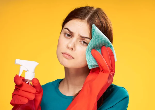 Emotionele reiniging dame rubber handschoenen huis reiniging gele achtergrond — Stockfoto