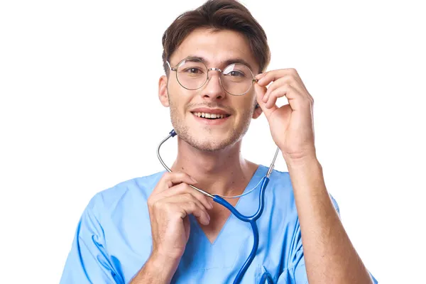 Hombre en uniforme médico usando gafas estetoscopio posando fondo aislado —  Fotos de Stock