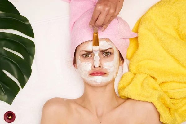 Vrolijke vrouw gezicht masker huid reinigen palmblad uitzicht van boven — Stockfoto