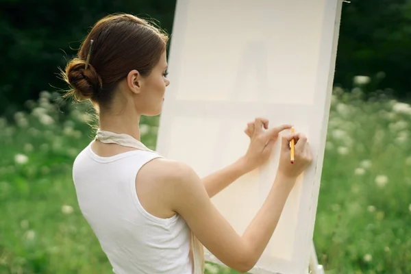 Önlüklü kadın sanatçı bir resim çiziyor. — Stok fotoğraf