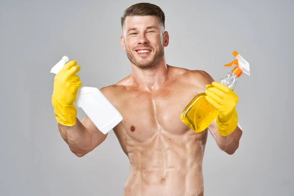 Man with pumped up muscular body detergent rubber service gloves — Stock Photo, Image