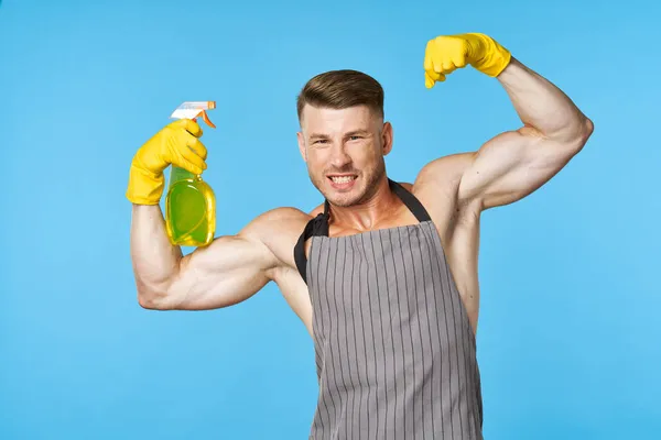 Hombre con un delantal detergente servicio de limpieza tareas domésticas — Foto de Stock