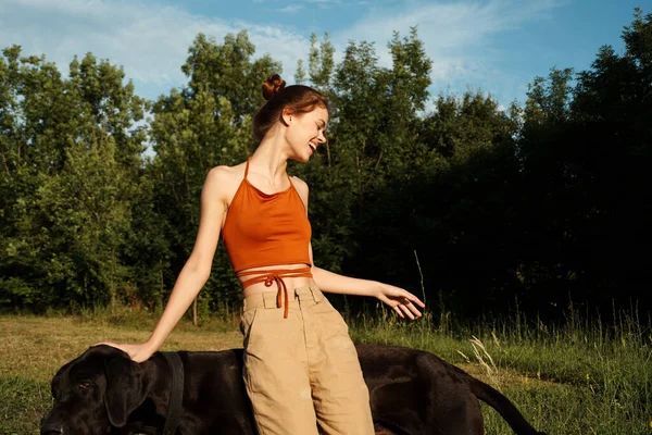 Cheerful woman outdoors with dog and fun nature — Stock Photo, Image