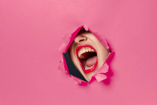 cheerful woman poster hole pink background and red lips