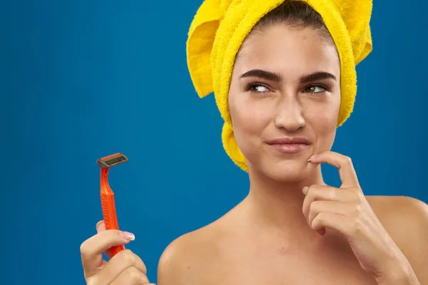 Wanita cantik pisau cukur di tangan perawatan kulit higienitas biru latar belakang — Stok Foto