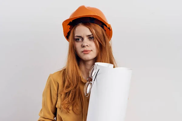 Female engineer in orange hard hat blueprints architect — Stock Photo, Image