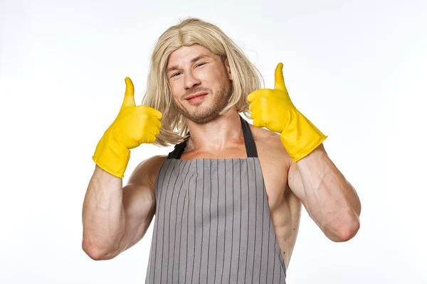 Чоловік в жовтих гумових рукавичках у жіночій прибиральниці позує — стокове фото