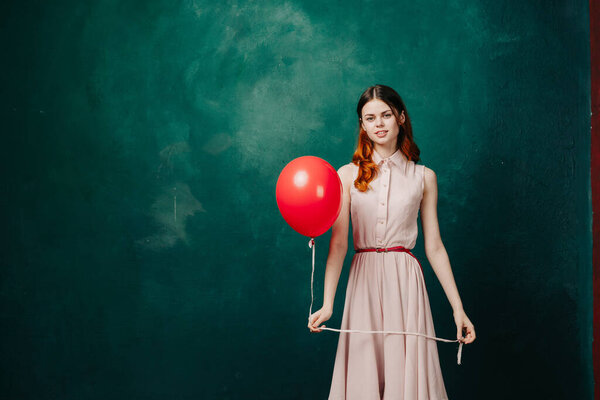 woman with red balloon celebration birthday green background