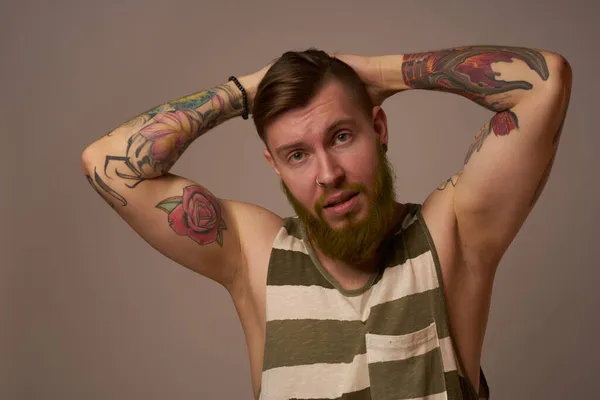 Handsome man with tattoos on his arms fashionable hairstyle emotions — Stock Photo, Image