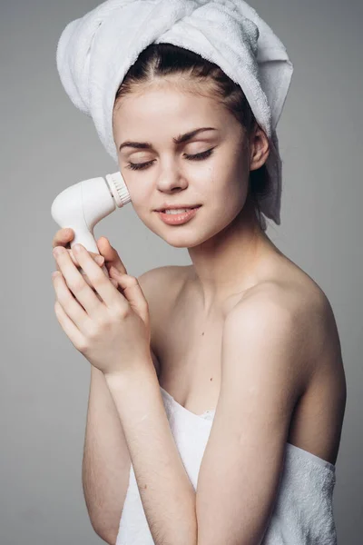 Mulher com toalha na cabeça massageador facial cuidados com a pele higiene — Fotografia de Stock