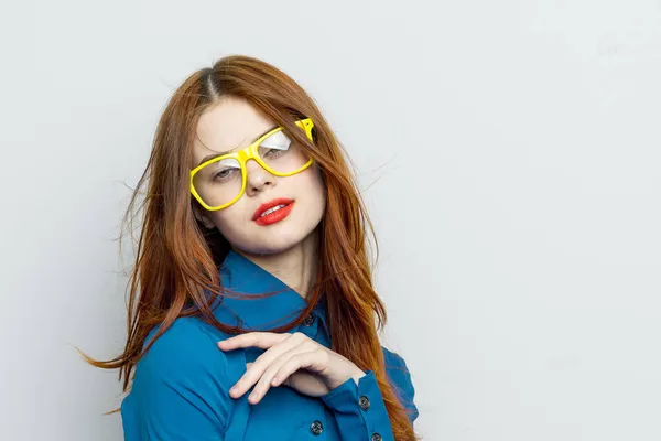 Business woman in blue shirt wearing yellow glasses emotions Royalty Free Stock Images