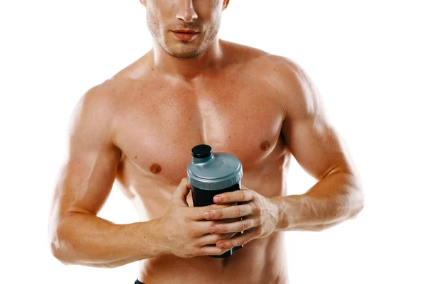 Athletischer Mann mit aufgepumpten muskulösen Körper Sport trinken Licht Hintergrund — Stockfoto
