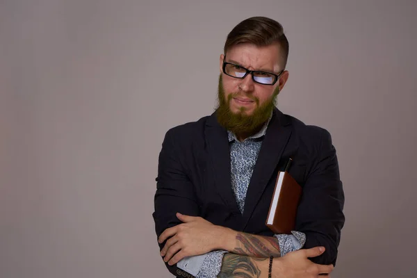 Stock image business man with glasses with tattoos on his arms office professionals