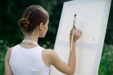 Kadın sanatçı doğa palet tablosu çizer yaratıcı manzara