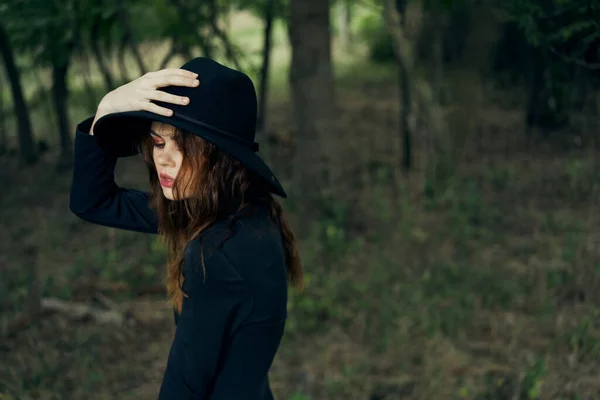Siyah şapkalı kadın ormanda fantezi kuruyor. — Stok fotoğraf